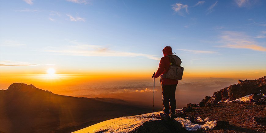 Man står på Kilimanjaro i soluppgången